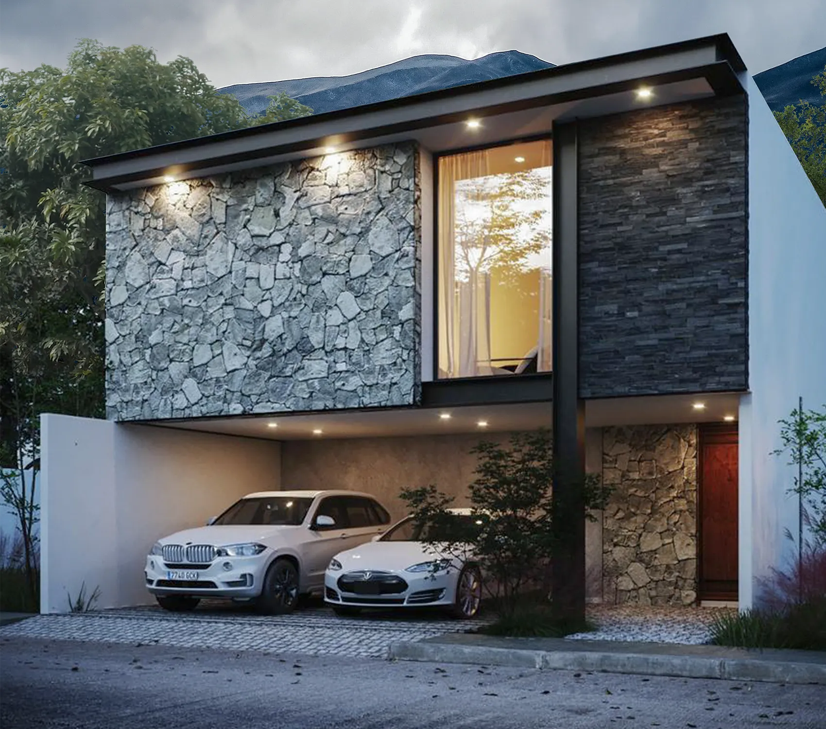 Fachada residencial moderna con iluminación arquitectónica: volúmenes revestidos en piedra natural (rústica y laminada) contrastando con un cielo dramático y entorno montañoso.